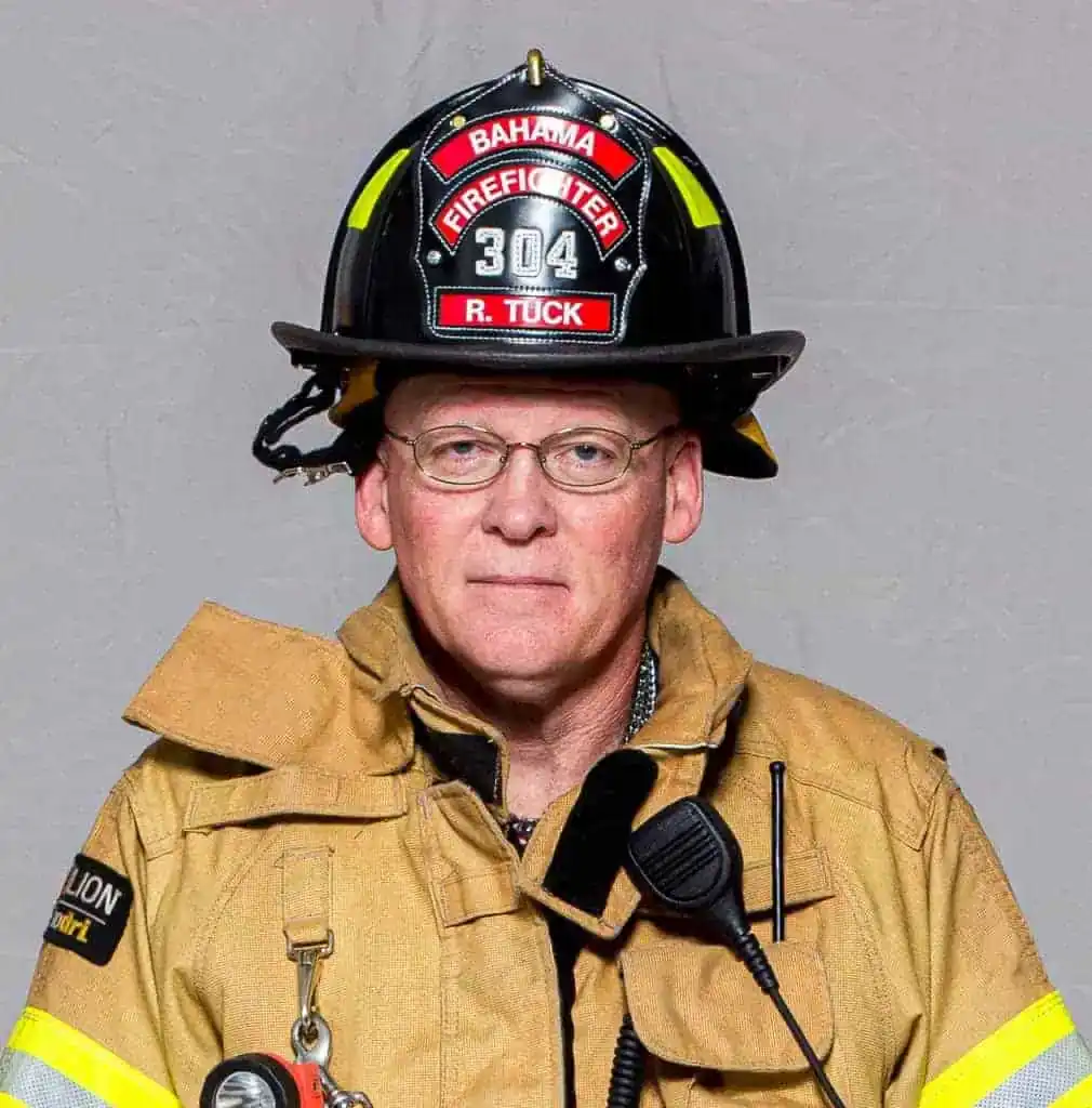 Dale Ellis, Deputy Chief of the Bahama Volunteer Fire Department, in full turnout gear and helmet labeled “Deputy Chief 101,” posing for a professional portrait.
