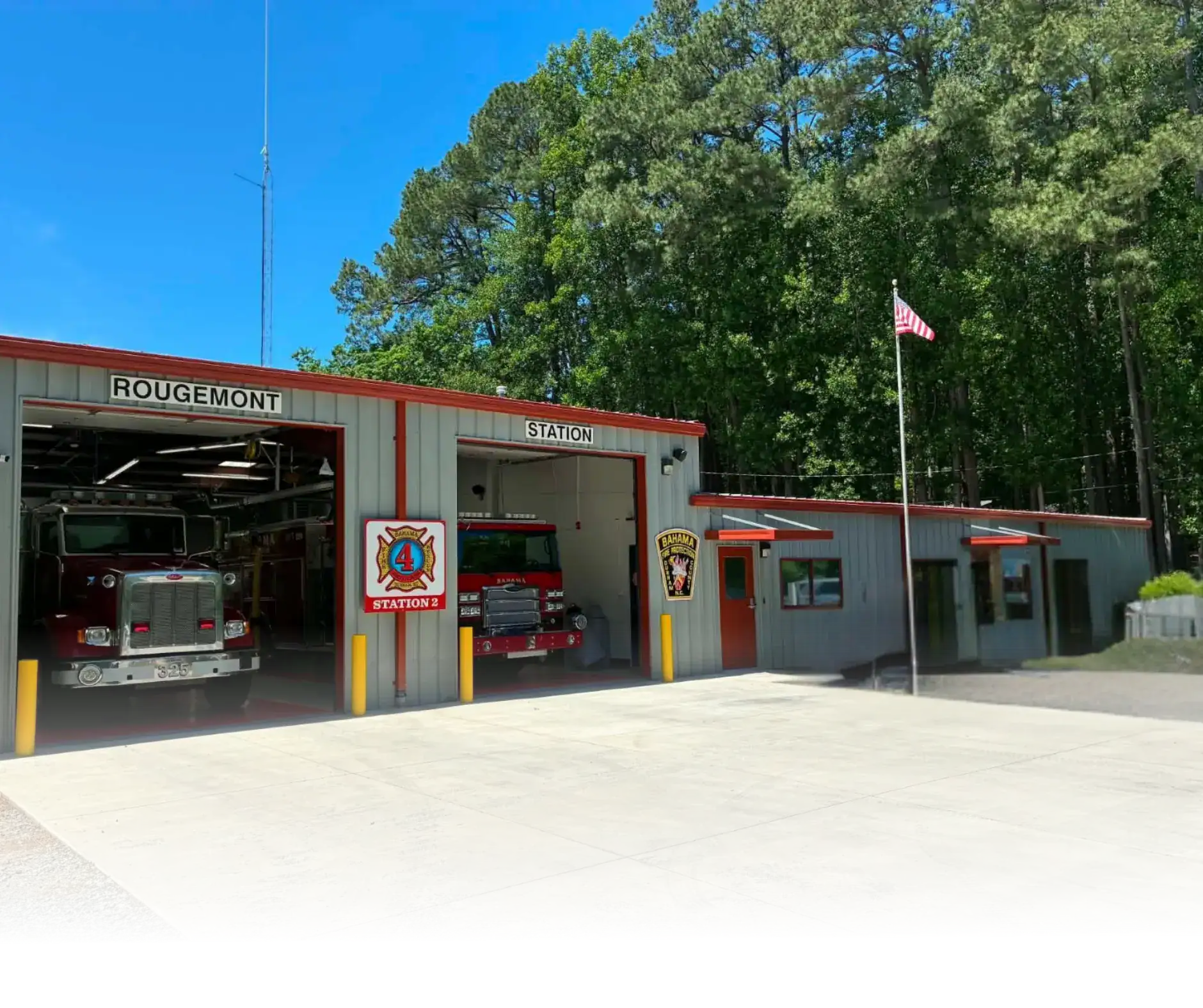 Front view of Station 2 at Bahama Fire & Rescue with two garage bays and a flat roof.